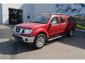 Front 3/4 View of 2011 Nissan Frontier SL Crew Cab 4x4 #5