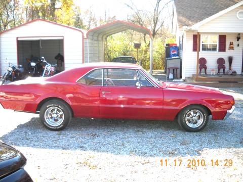 Red Oldsmobile Cutlass Supreme Sedan.  Click to enlarge.